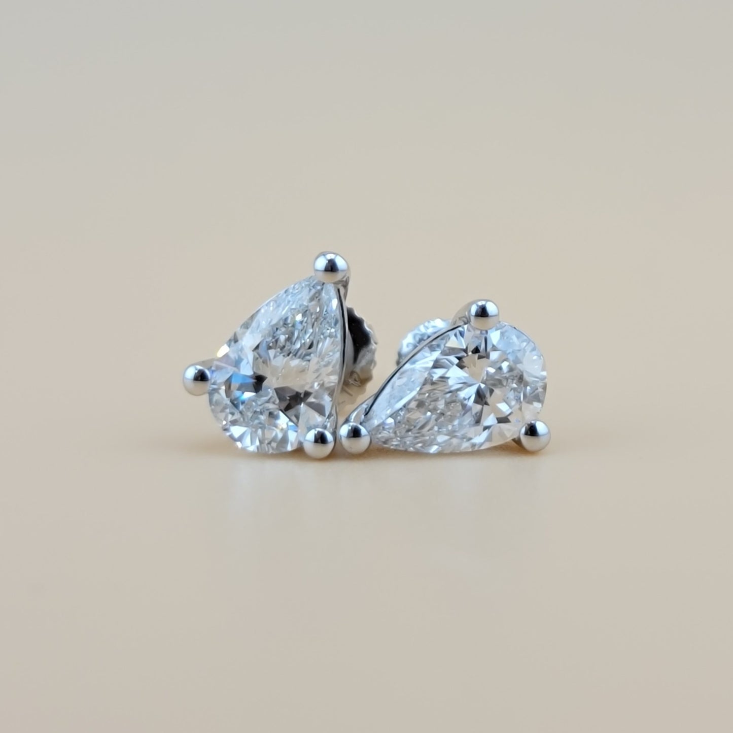 2 carats lab grown diamond pear cut solitaire earrings in 14k gold