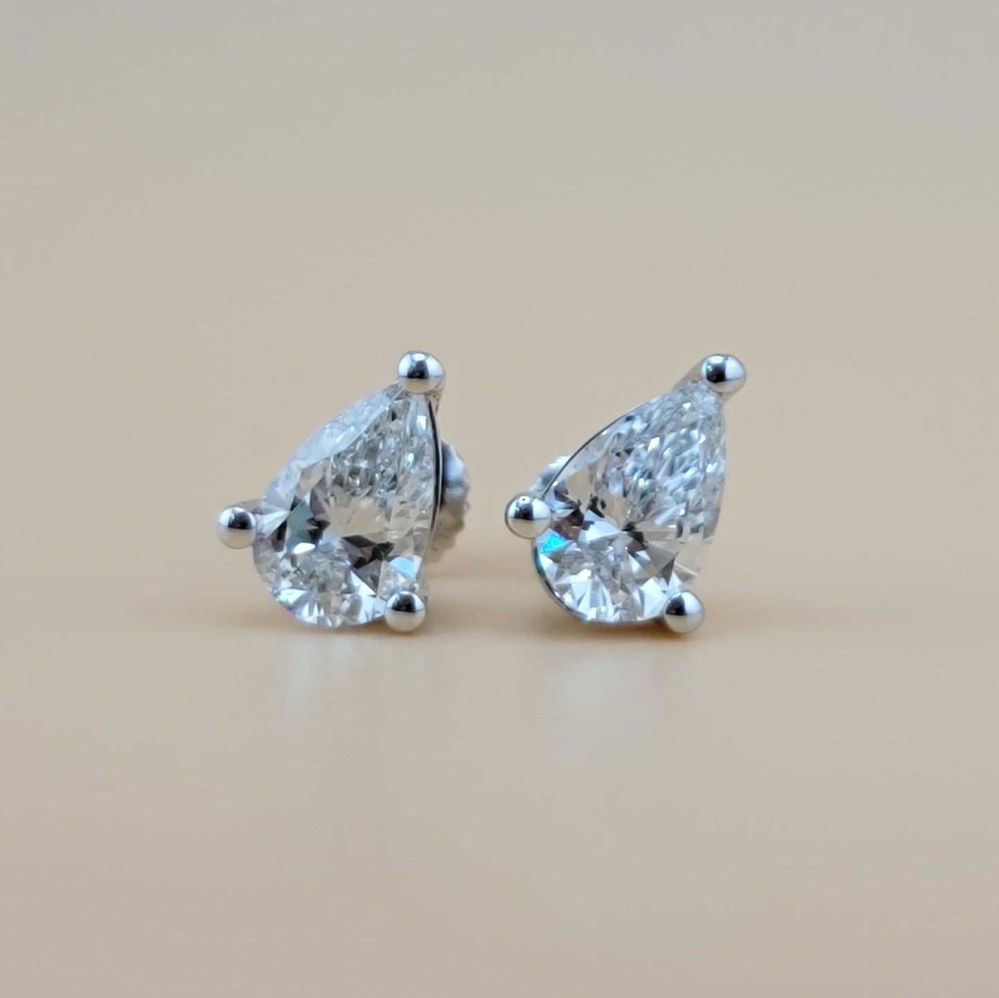 2 carats lab grown diamond pear cut solitaire earrings in 14k gold
